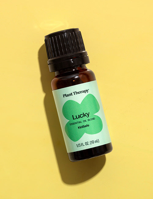 Lucky Essential Oil bottle on yellow background