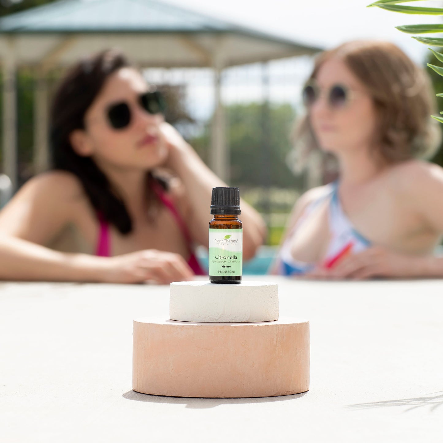 Citronella Essential Oil pictured next to the pool