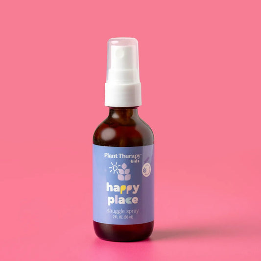 Bottle of 'Happy Place' spray with a label on a pink background